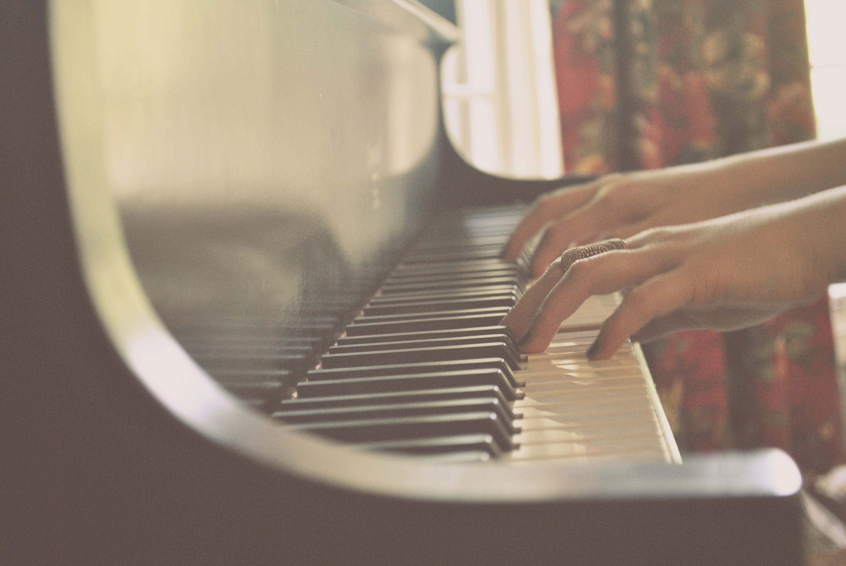 Piano keys and hands creating music